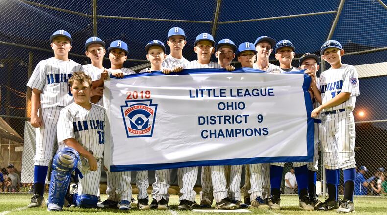 Hamilton West Side’s players pose for a photo Thursday night after winning the Little League District 9 tournament championship with a 15-0 victory over Hamilton-Fairfield at West Side. NICK GRAHAM/STAFF