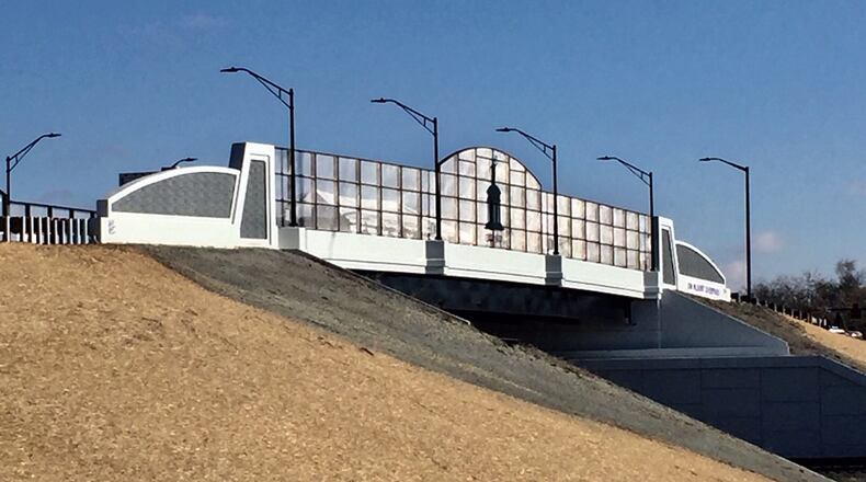 More than a century after plans were first proposed to deal with railroad tracks’ negative impact on traffic, the city of Hamilton dedicated the Jim Blount South Hamilton Crossing overpass. The five-lane overpass was touted by Hamilton Mayor Pat Moeller - and other local and state officials - as a “game-changer” for the city and the regional that will speed economic development and add to the quality of life in the Butler County city. FILE