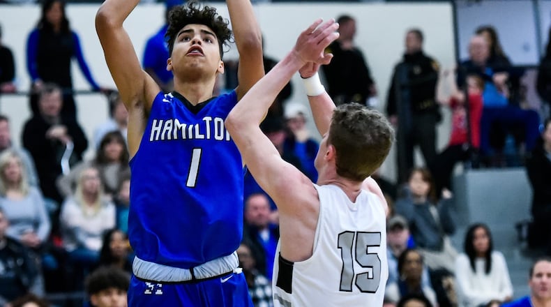 Hamilton’s Trey Robinson puts up a shot defended by Lakota East’s Kaden Fuhrmann during their basketball game Friday, Jan. 11 at Lakota East High School in Liberty Township. Hamilton won 65-62. NICK GRAHAM/STAFF