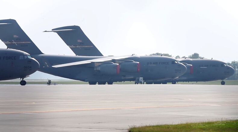 Six Air Force C-17 transport jets with the 445th Airlift Wing sit idle at Wright-Patterson Air Force Base during a partial federal government shutdown in 2013. TY GREENLEES / STAFF FILE PHOTO
