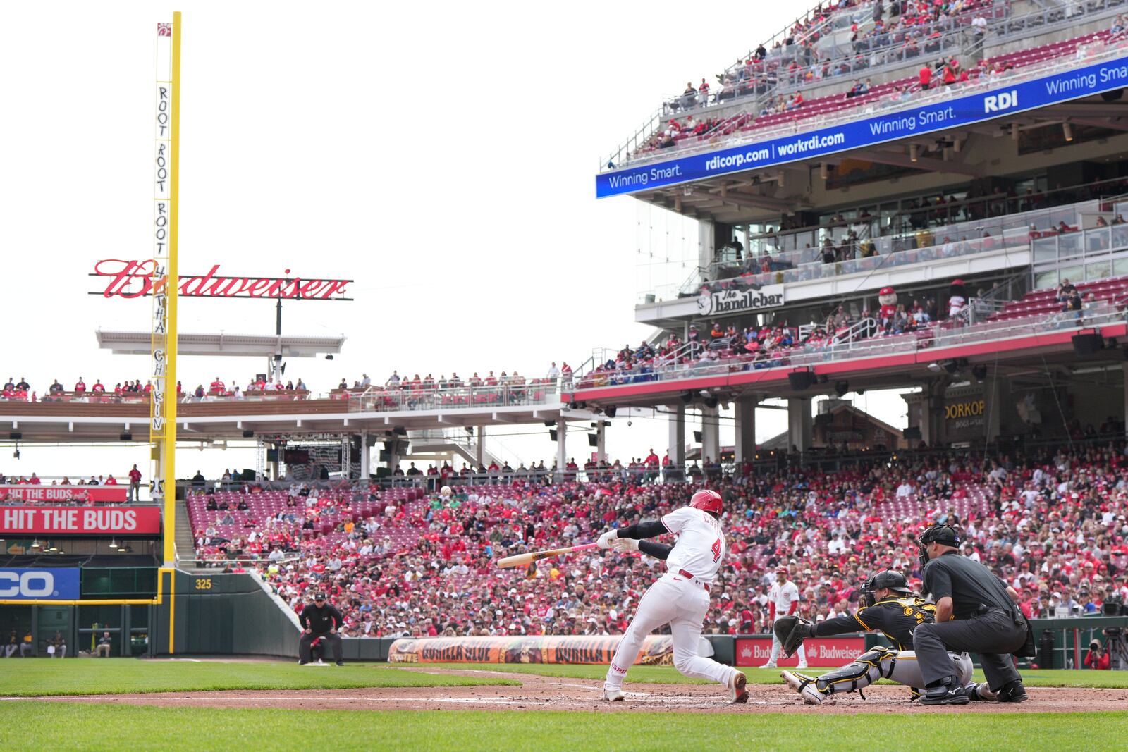 Cincinnati Reds' Santiago Espinal (4) hits a two-run single during the third inning of a baseball game against the Pittsburgh Pirates, Sunday, April 13, 2025, in Cincinnati. (AP Photo/Jeff Dean)