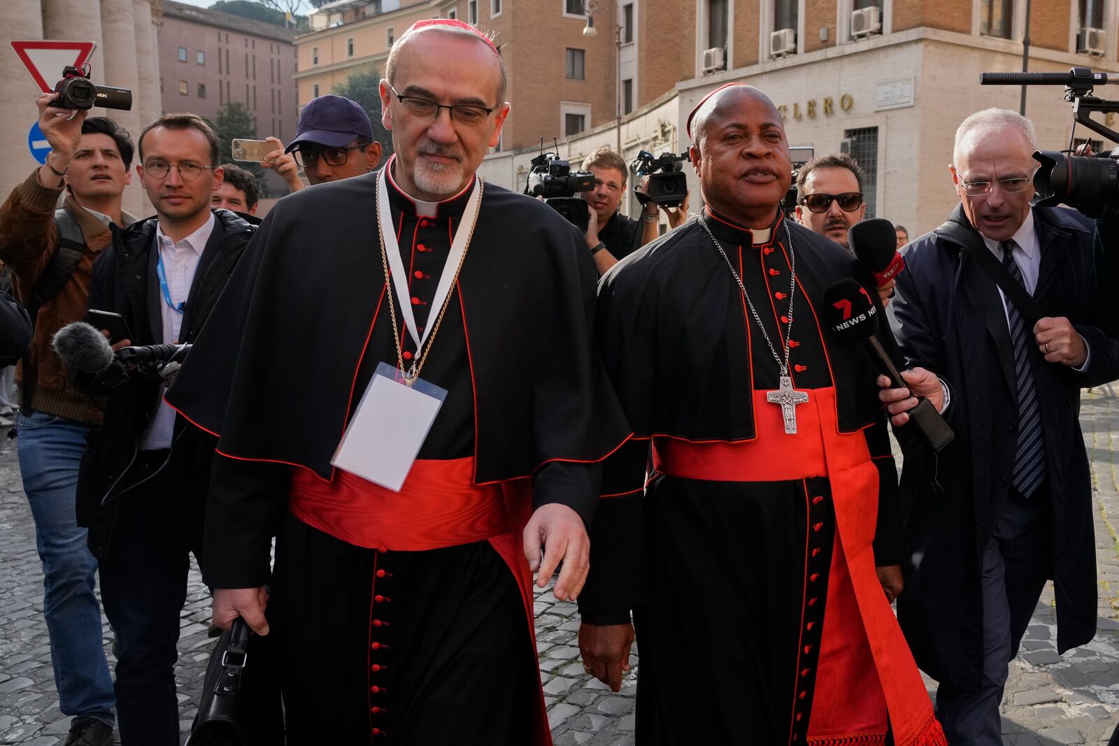 Cardinal Pierbattista Pizzaballa, left, and Cardinal Fridolin Ambongo Besungu arrive for a college of cardinals' meeting, at the Vatican, Monday, April 28, 2025. (AP Photo/Gregorio Borgia)