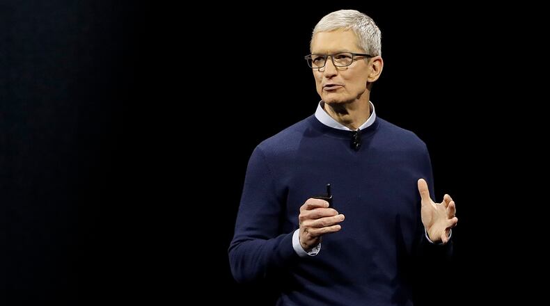 FILE - In this Monday, June 5, 2017, file photo, Apple CEO Tim Cook speaks during an announcement of new products at the Apple Worldwide Developers Conference in San Jose, Calif. Cook has collected $89.6 million from a lucrative 10-year deal that he signed as an incentive to keep the iPhone maker at the forefront of the technology industry after he took over the reins in 2011 from company co-founder Steve Jobs. The windfall detailed in a Monday, Aug. 28, 2017, regulatory flowed from 560,000 Apple shares sold during the past week. Apple set aside $46.4 million to cover Cook's taxes. (AP Photo/Marcio Jose Sanchez, File)