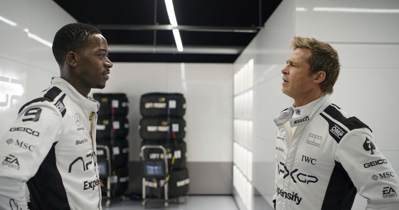 This image released by Apple TV+ shows Damson Idris as Joshua Pearce, left, and Brad Pitt as Sonny Hayes in a scene from "F1 The Movie." (Apple TV+ via AP)