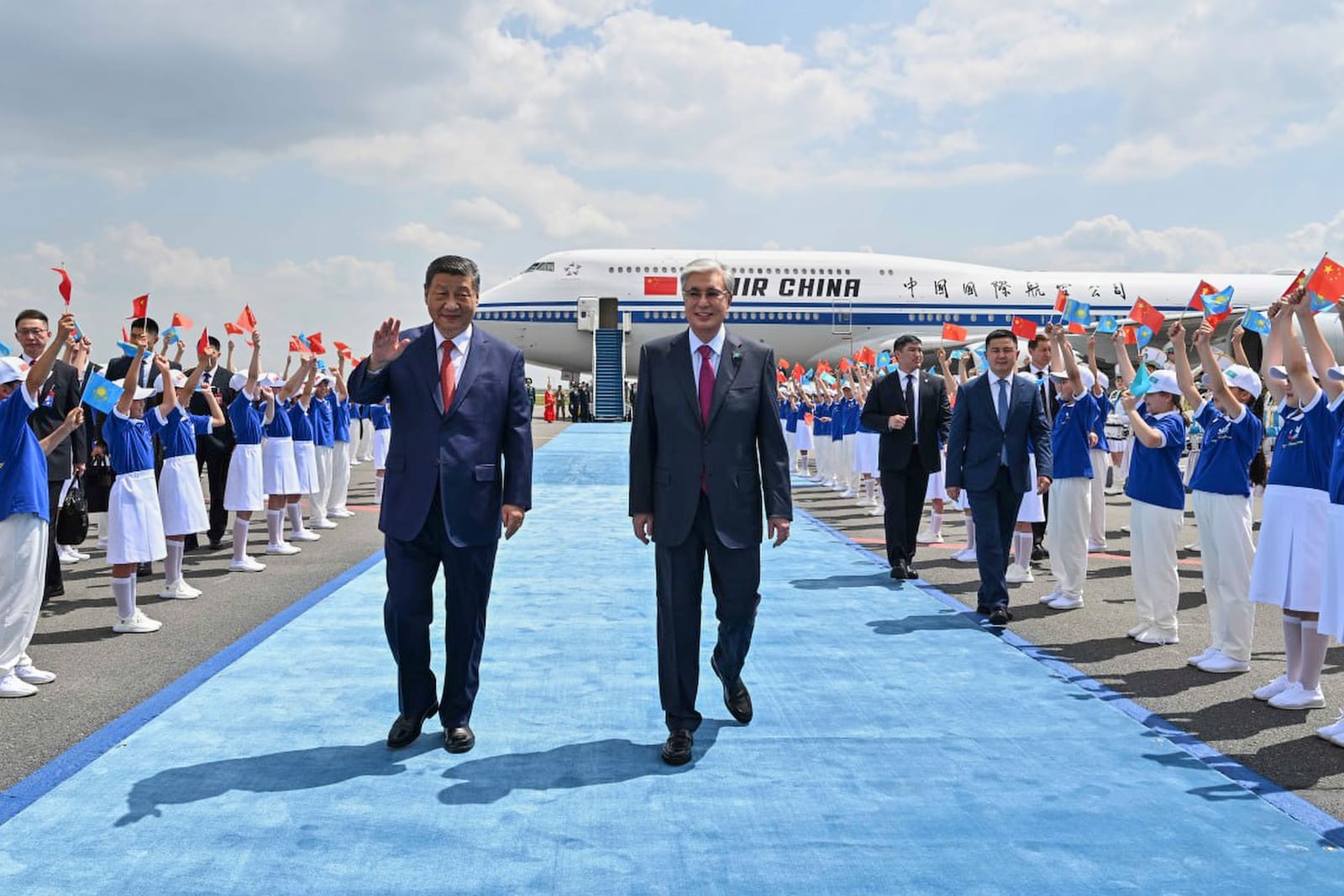 In this photo released by Kazakhstan's Presidential Press Office, Chinese President Xi Jinping, left, walks with Kazakh President Kassym-Jomart Tokayev upon his arrival at an international airport outside Astana, Kazakhstan, on Monday, June 16, 2025. (Kazakhstan's Presidential Press Office via AP)
