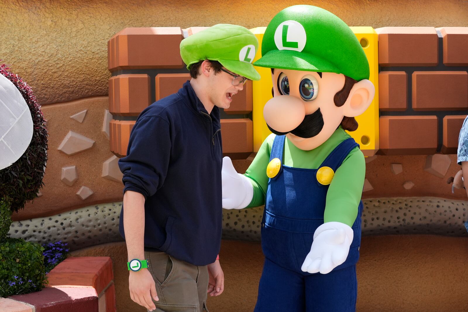 A guest interacts with a character in Super Nintendo World at Epic Universe at Universal Resort Orlando Thursday, April 10, 2025, in Orlando, Fla. (AP Photo/John Raoux)
