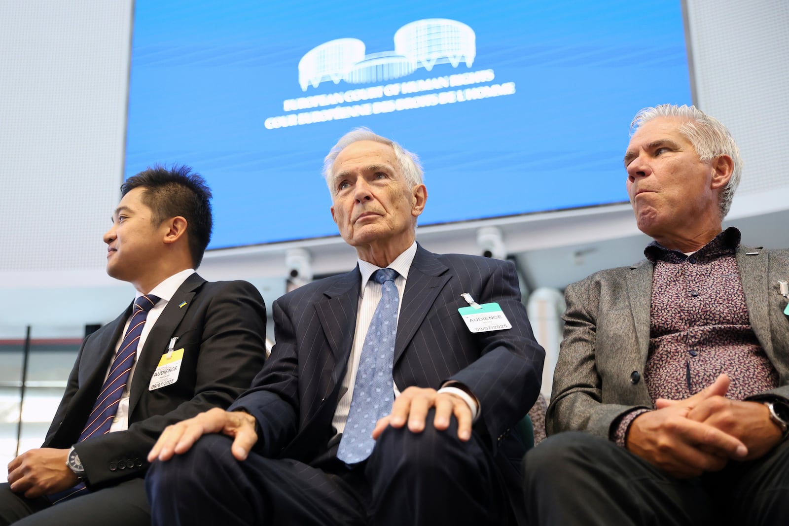Netherland's Anton Kotte, center, who lost his son and other family members in the the downing of Malaysia Airlines flight MH17, sits in the European Court of Human Rights before it issues a landmark set of rulings about alleged Russian violations in Ukraine since 2014, including the downing of Malaysia Airlines flight MH17, Wednesday, July 9, 2025 in Strasbourg, eastern France. (AP Photo/Antonin Utz)
