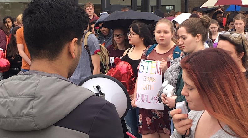 Students at the Dayton Regional STEM School walked out of school Wednesday, Feb. 21, 2018, in memory of the 17 individuals who died during the mass shooting at Marjory Stoneman Douglas High School in Broward, Fla. WILL GARBE / STAFF