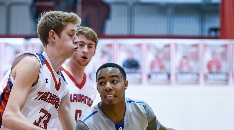 Cincinnati Christian’s Dylan Woods dribbles to the basket while being defended by Talawanda’s Josh DeWitt during Madison’s Brian Cook Classic on Dec. 29, 2016. NICK GRAHAM/STAFF
