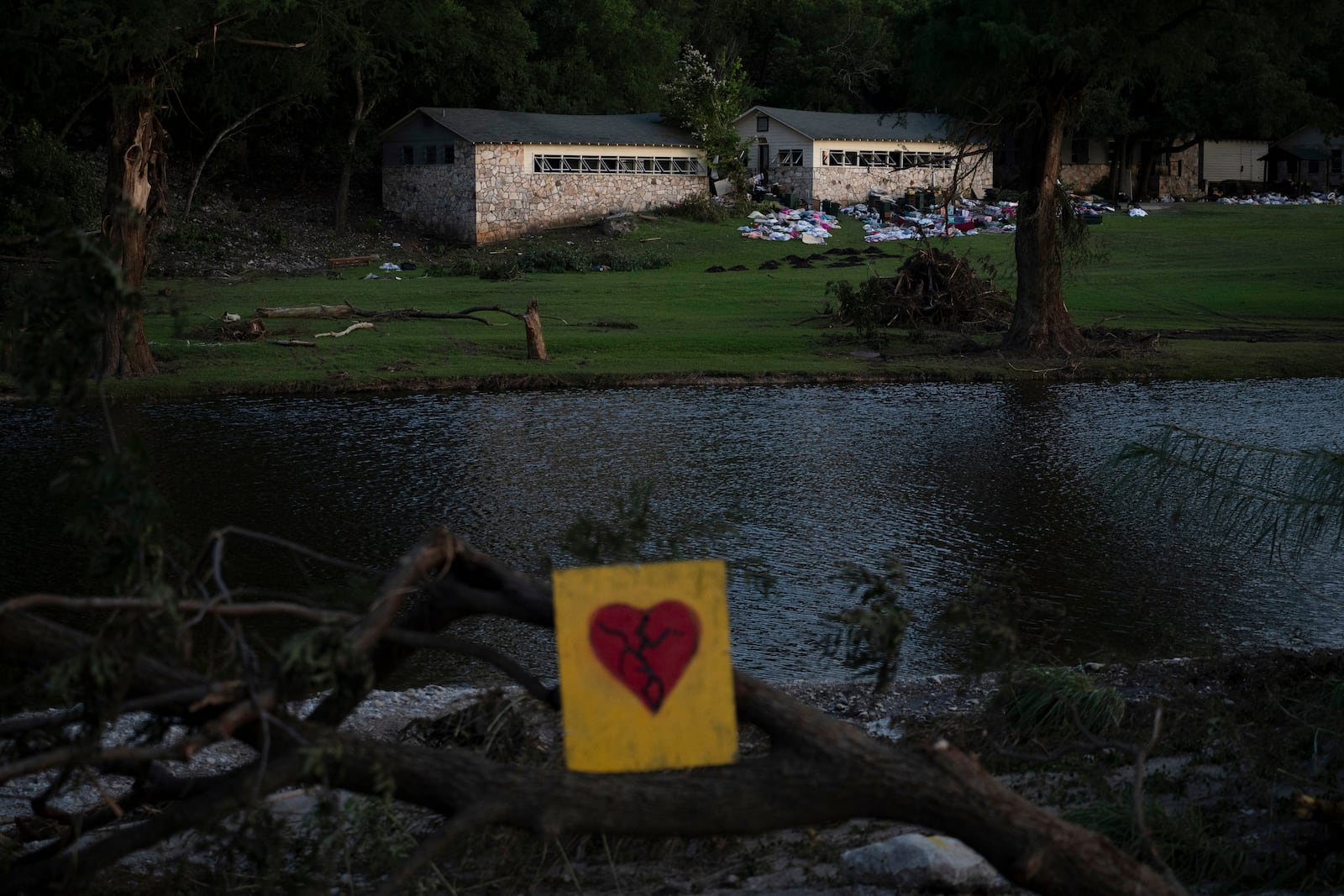 A broken heart sign is displayed near Camp Mystic on Tuesday, July 8, 2025, after a flash flood swept through the area in Hunt, Texas. (AP Photo/Eli Hartman)