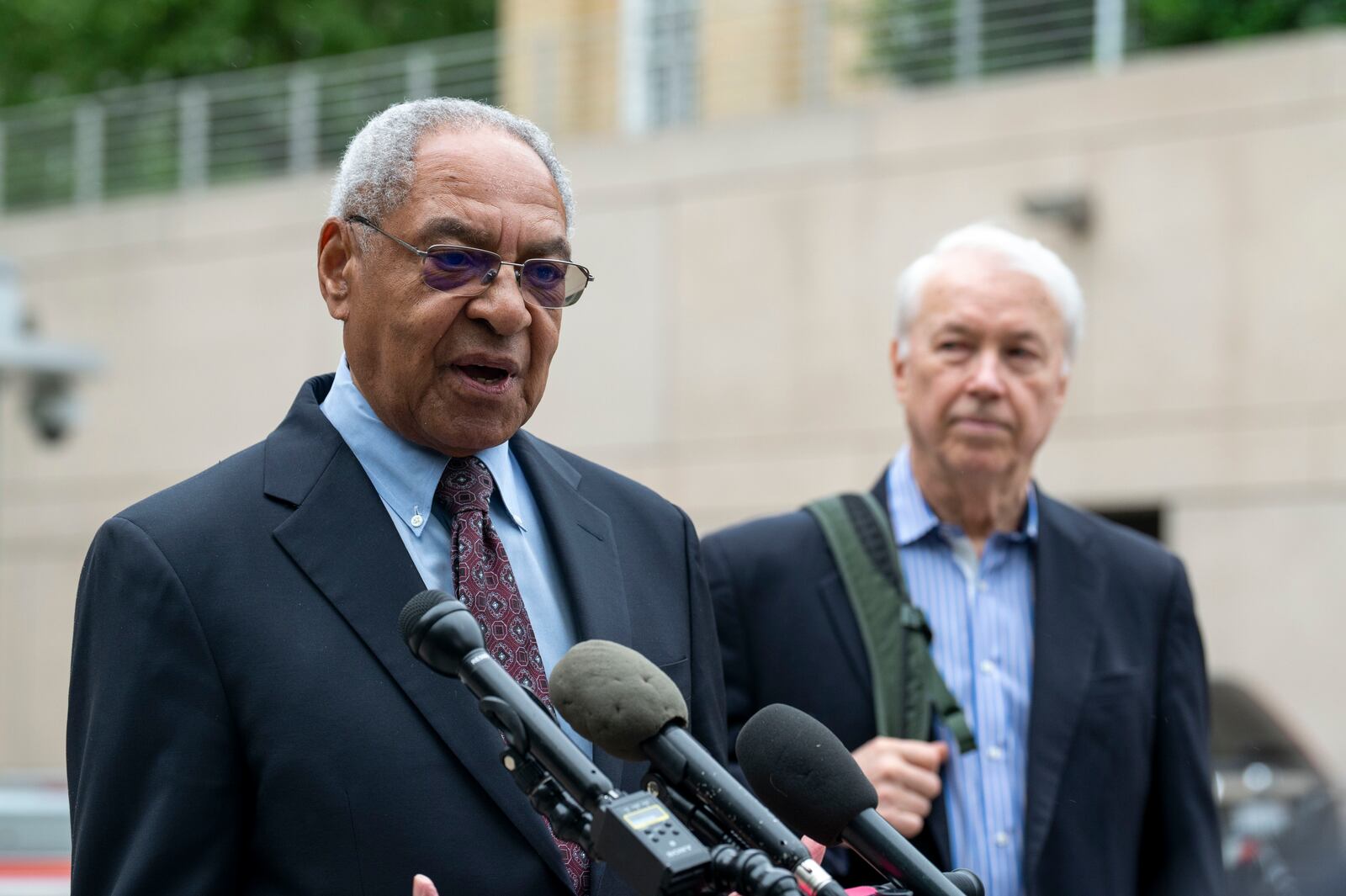 U.S. Institute of Peace (USIP) acting President George Moose, left, and USIP acting counsel George Foote take part in a newss conference outside the Institute, Wednesday, May 21, 2025 in Washington. (AP Photo/Kevin Wolf)