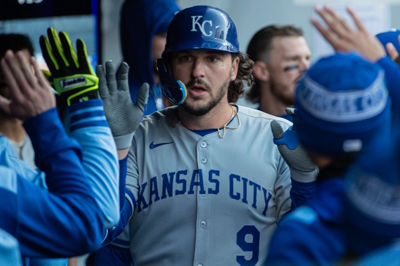 Kansas City Royals' Vinnie Pasquantino (9) is greeted in the dugout after hitting a solo home run off Cleveland Guardians starting pitcher Luis Ortiz (45) during the fourth inning of a baseball game in Cleveland, Saturday, April 12, 2025. (AP Photo/Phil Long)
