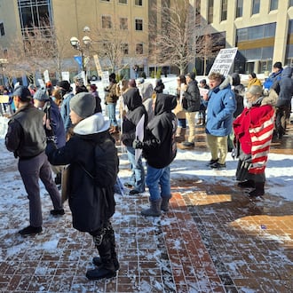 About 125 people rallied on Courthouse Square in Dayton on Saturday calling for permanent residency for Haitians in the Springfield area. MICHAEL KURTZ / STAFF