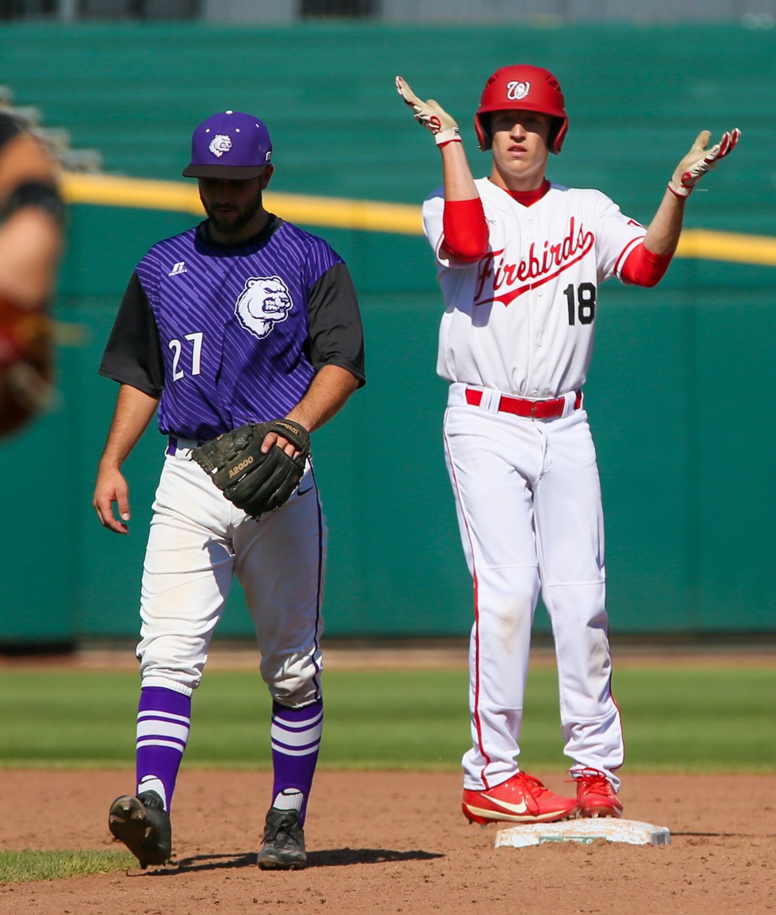 Lakota West’s Eric Hooper (18) pulls into second base with a double Friday as Massillon Jackson second baseman Trey Wright walks away from the base during a Division I state semifinal at Huntington Park in Columbus. GREG LYNCH/STAFF