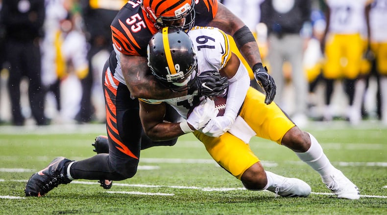 Cincinnati Bengals linebacker Vontaze Burfict tackles Pittsburgh Steelers wide receiver JuJu Smith-Schuster during their game Sunday, Oct. 14 at Paul Brown Stadium in Cincinnati. The Steelers won 28-21. NICK GRAHAM/STAFF