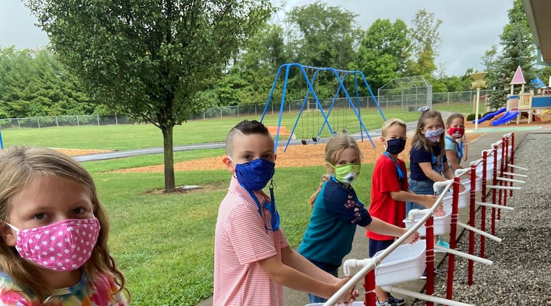 Kings Schools teacher Rachel Manley and her father built a series of hand washing stations next to the playground at South Lebanon Elementary to better combat the spread of the coronavirus. (Provided Photo\Journal-News)
