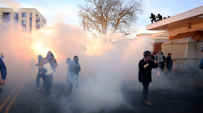 Federal agents lobbed tear gas and flash bangs at protesters in front of the ICE building on Jan. 31, 2026, in Portland, Ore. (Allison Barr/The Oregonian via AP)