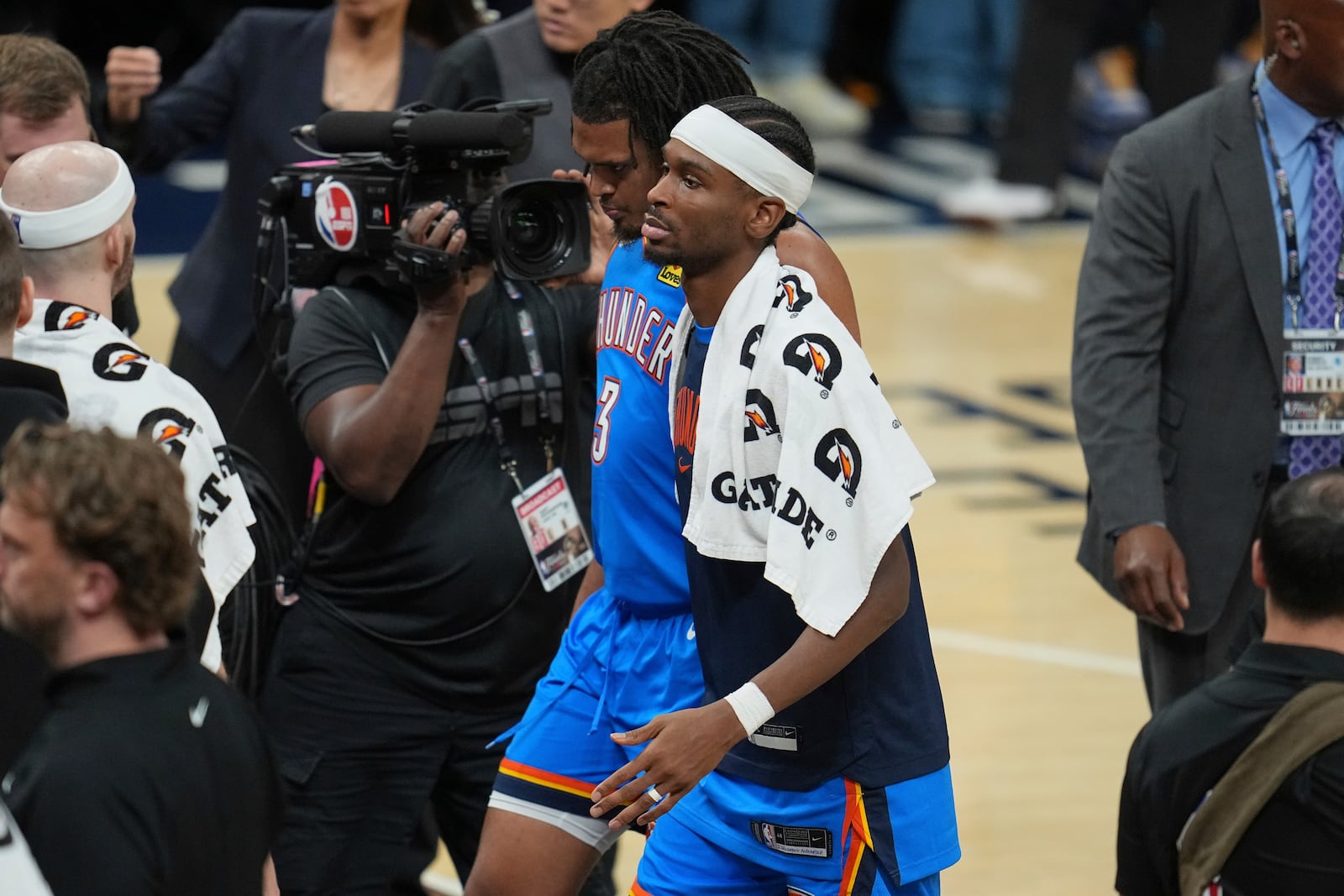Oklahoma City Thunder guard Shai Gilgeous-Alexander and forward Dillon Jones (3) leave the court after Game 6 of the NBA Finals basketball series against the Indiana Pacers, Thursday, June 19, 2025, in Indianapolis. (AP Photo/Michael Conroy)