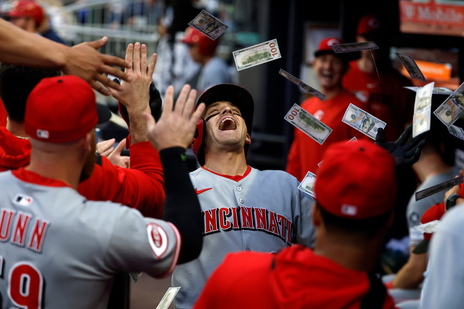 Cincinnati Reds' TJ Friedl celebrates with teammates after hitting a home run during the third inning of a baseball game against the Atlanta Braves, Wednesday, May 7, 2025, in Atlanta. (AP Photo/Butch Dill)
