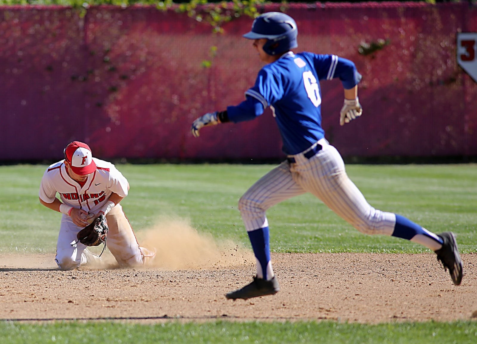Fairfield second baseman Kaleb Ford fields a ground ball as Hamilton’s Payton Pennington runs to second base Sunday at Joe Nuxhall Field in Fairfield. CONTRIBUTED PHOTO BY E.L. HUBBARD