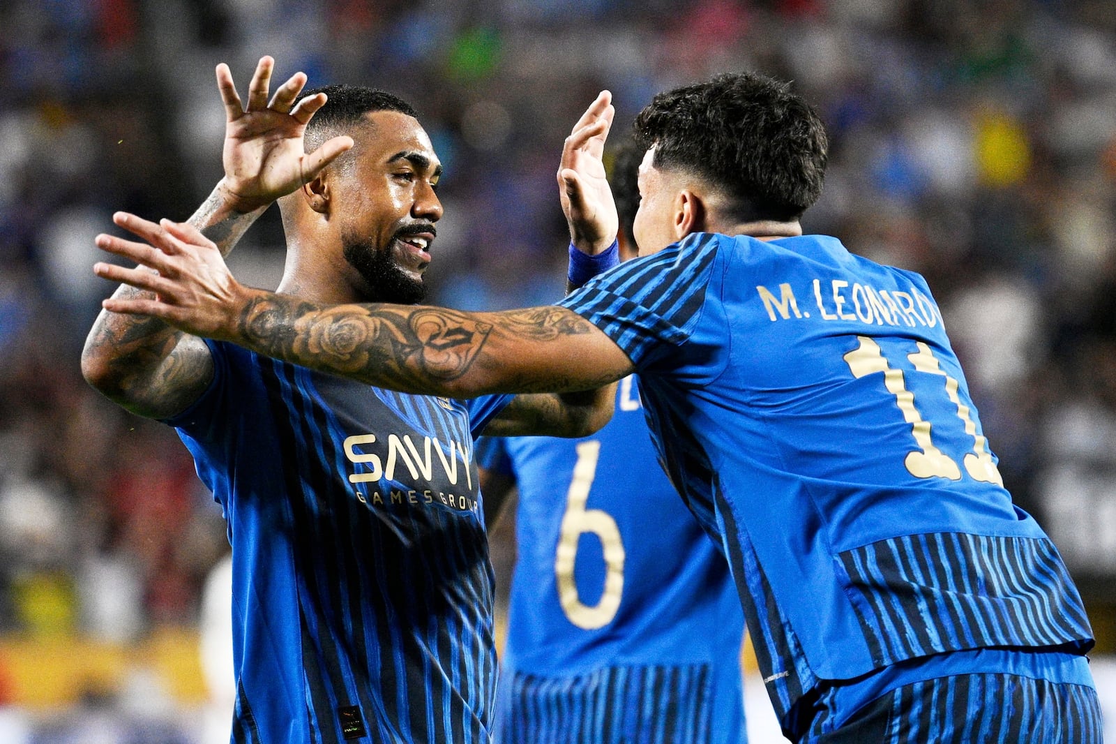 Al-Hilal's Malcom is congratulated by Al-Hilal's Marcos Leonardo after scoring his teams second goal during the Club World Cup round of 16 soccer match between Manchester City and Al Hilal in Orlando, Fla., Monday, June 30, 2025. (AP Photo/Phelan Ebenhack)