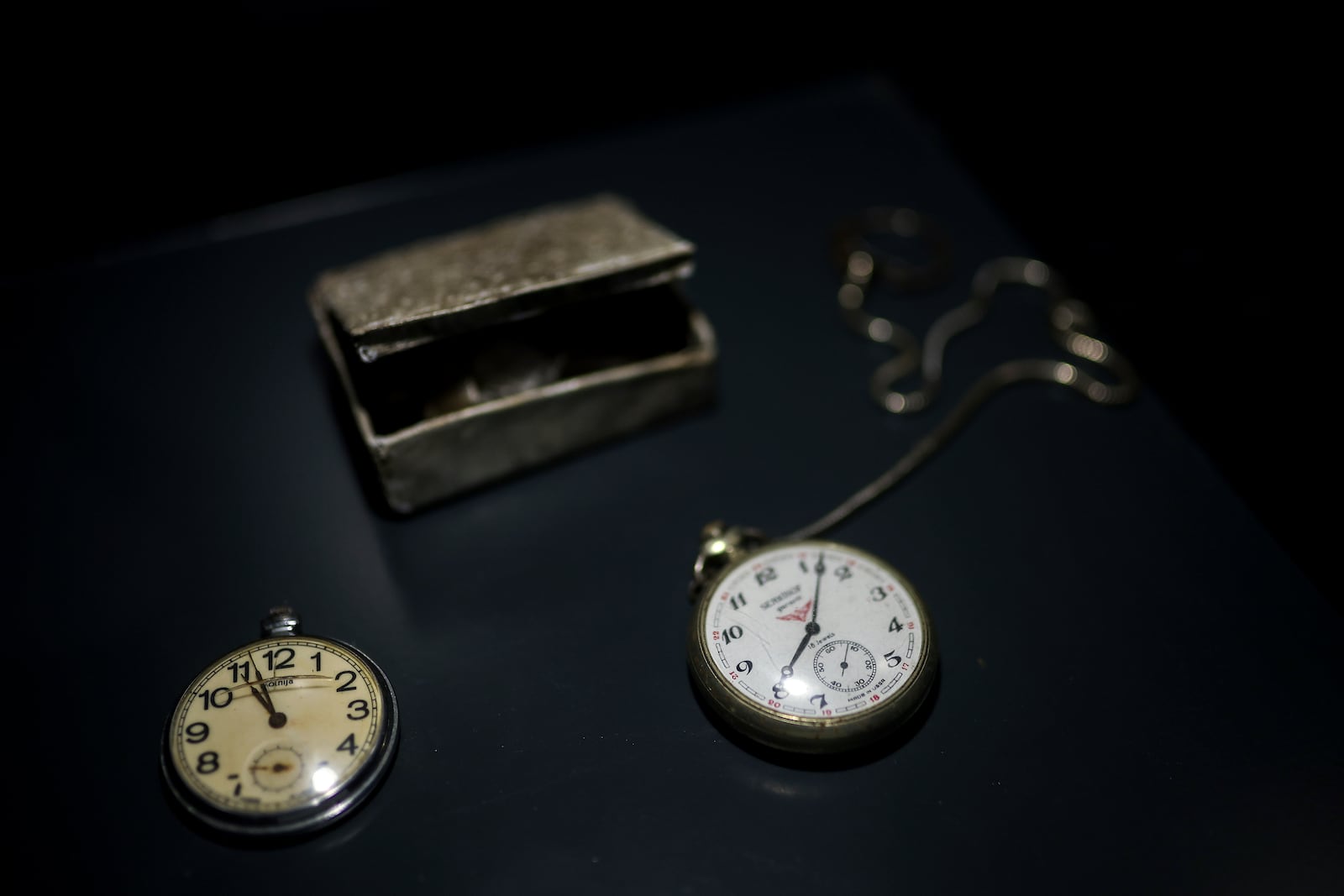 Pocket watches found in a mass grave are shown as a part of the exhibition "Lives Beyond the Fields of Death" opened at the Srebrenica Memorial Center in Potocari, Bosnia, Thursday, July 10, 2025. (AP Photo/Armin Durgut)