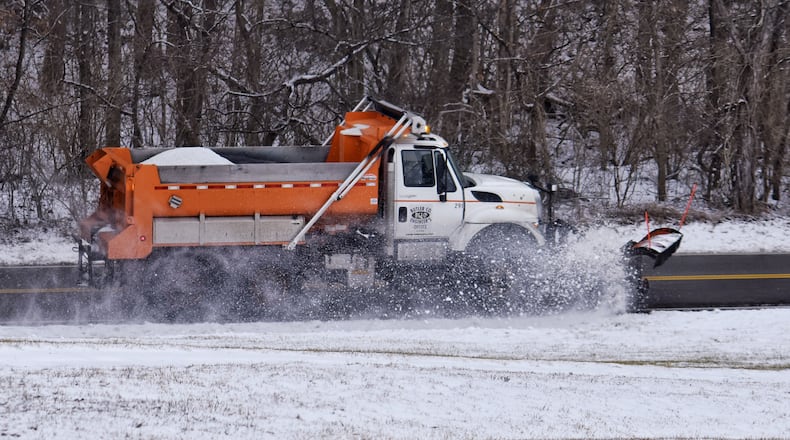 A Butler County Engineer's Office salt truck plows snow from a section of Elk Creek Road in Madison Township Monday, February 1, 2021. NICK GRAHAM / STAFF