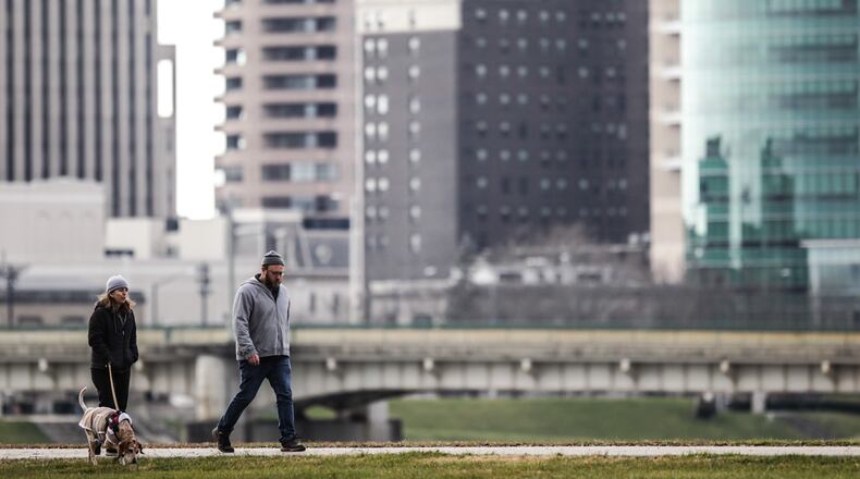 Mark and Caroyn Reed and their dog, Sadie, from Dayton, hike on the trails around Deeds Point Metro Park Tuesday Dec. 22, 2020. A great way to stay healthy and safe during this holiday COVID-19 season is to hike or run on the trails around Dayton. JIM NOELKER