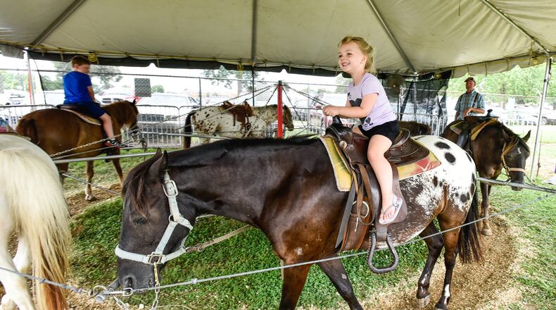 Elana Meacham, 3, rides a pony from High Winds Farm at the Butler County Fair Monday, July 23 in Hamilton. NICK GRAHAM/STAFF