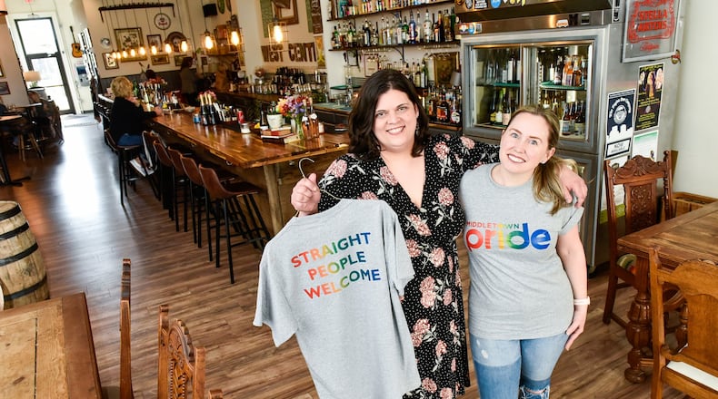 Melissa Kutzera, left, and Monica Nenni, owners of West Central Wine show off t-shirts being sold to raise money for the upcoming pride parade Tuesday, April 16 in Middletown. NICK GRAHAM/STAFF