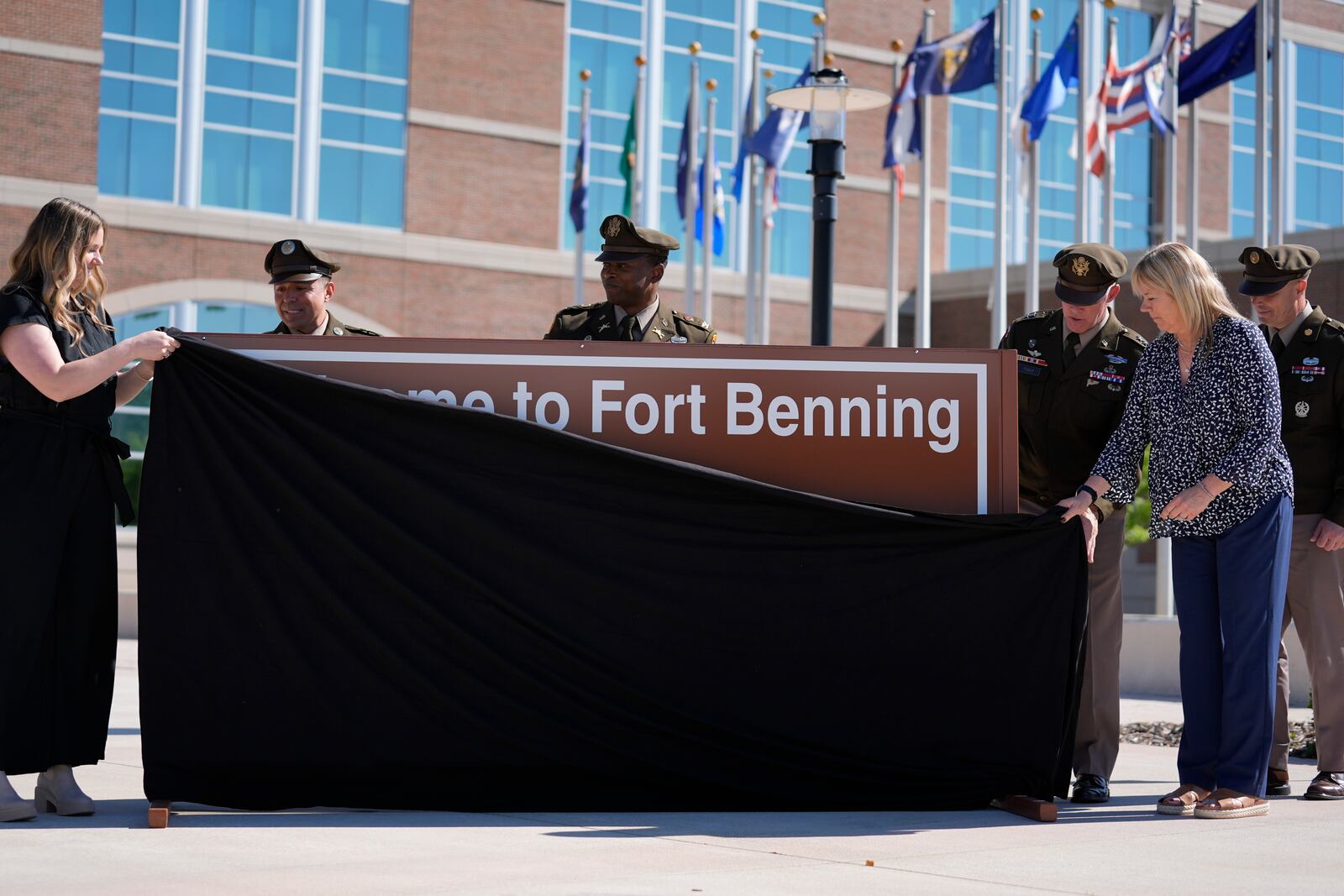 Ms. Sue Conger-Williams, right, Fred Benning's granddaughter unveils a new sign at Fort Benning during a ceremony honoring new namesake on Wednesday, April 16, 2025, in Fort Benning, Ga. (AP Photo/Brynn Anderson)