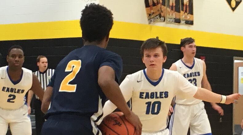 Middletown Christian’s Seth Wolfenbarger (10) guards Mylan Hall (2) of Cincinnati College Prep Academy on Saturday night during a Division IV sectional final at Taylor. RICK CASSANO/STAFF