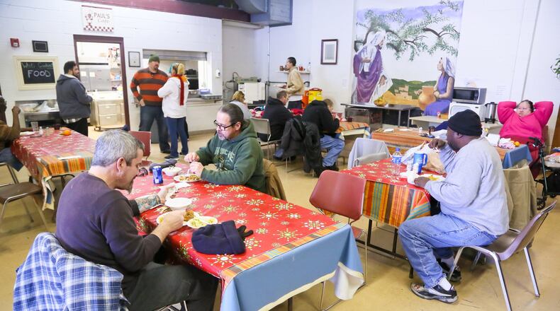 In this 2016 file photo, residents eat lunch at the Chosen homeless shelter at Serve City in Hamilton. GREG LYNCH / STAFF