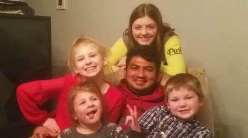 This photo from a few years ago shows Jose Antonio Alvarenga with April Alvarenga's four children, who he has raised with April for years. CONTRIBUTED PHOTO