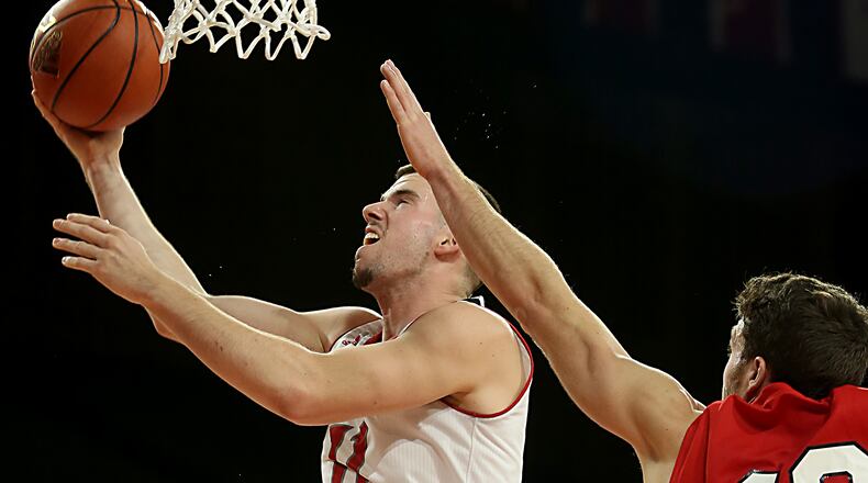 Miami forward Logan McLane scores while covered by Olivet forward R.J. Haas during their game at Millett Hall in Oxford Thursday, Dec. 29, 2016. Contributed photo / E.L. Hubbard