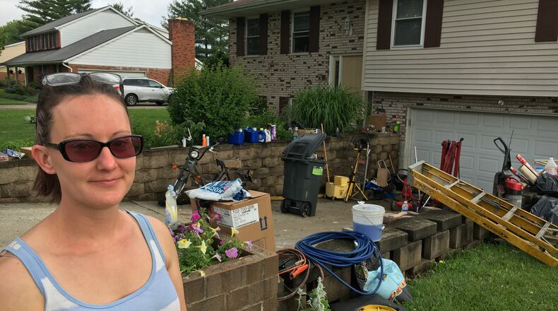Alicia Johnson, who lives on Taylor School Road in Seven Mile, calls the items lost in Wednesday’s flooding “just stuff” but it’s painful losing memories that can’t be replaced. RICK McCRABB/STAFF