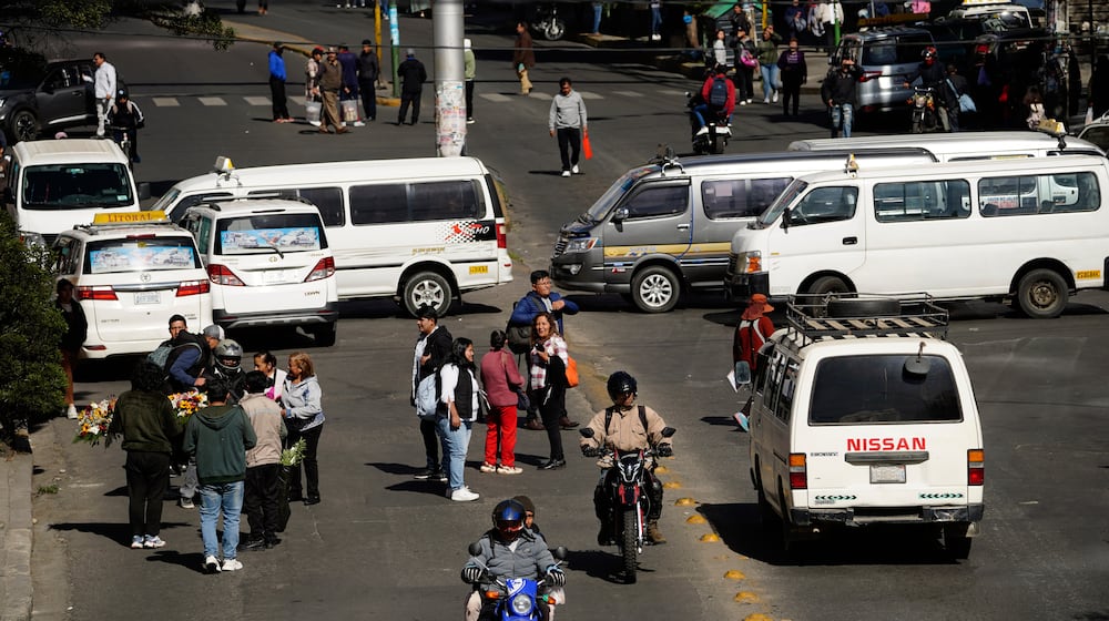 People walk during strike by the public transportation sector in La Paz, Bolivia, Friday, Dec. 19, 2025, after President Rodrigo Paz announced the end of fuel subsidies. (AP Photo/Freddy Barragan)