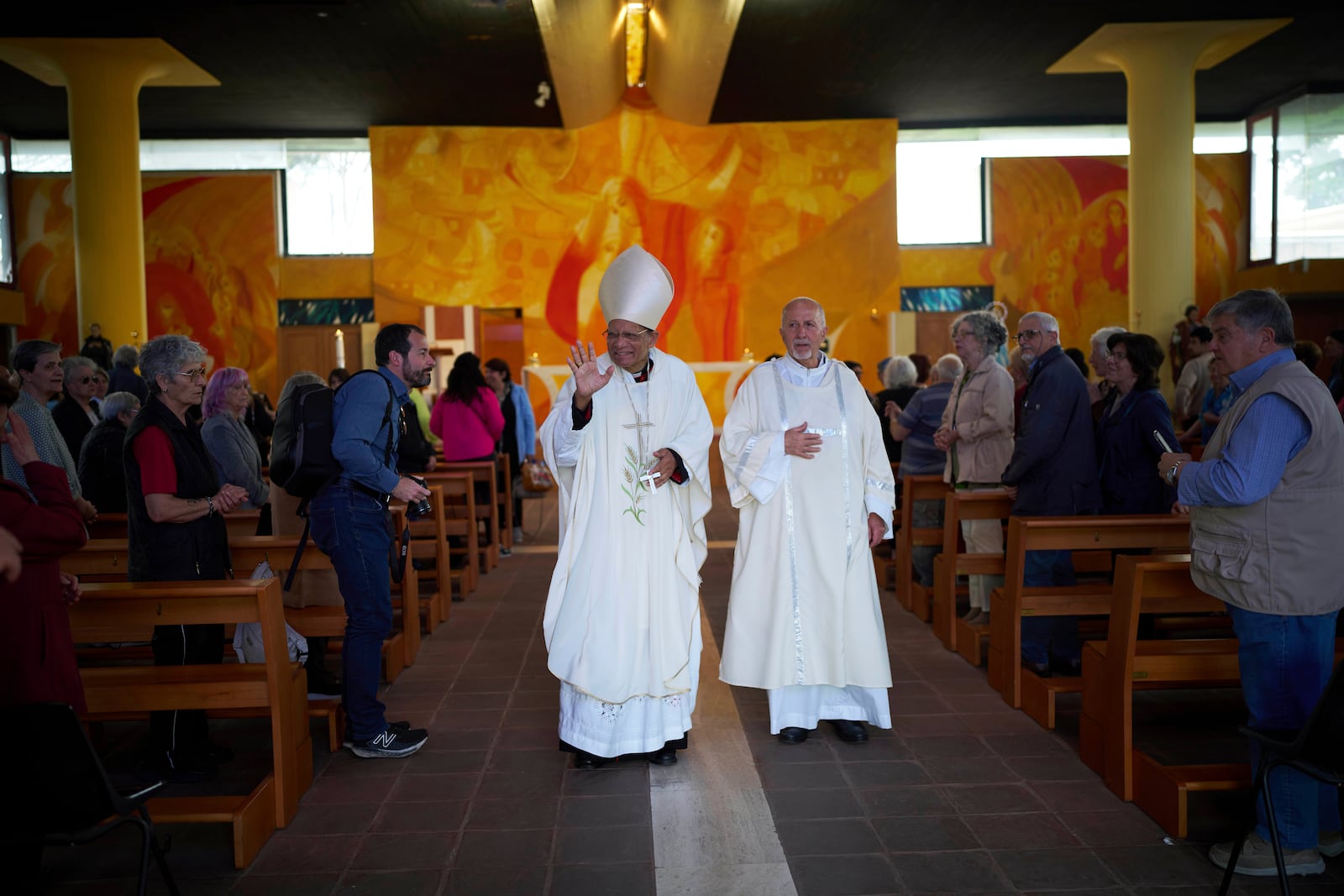Cardinal Oswald Gracias, left, leaves after leading a mass in San Paolo Della Croce parish church in Corviale neighbourhood, in Rome, Sunday, May 4, 2025. (AP Photo/Alessandra Tarantino)