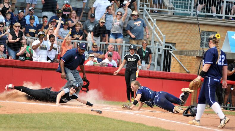 Lakota East’s Cali Hoffman beats the tag attempt by Louisville catcher Kaycee Ollis and scores a run Saturday during the Division I state championship softball game at Firestone Stadium in Akron. The game was suspended by inclement weather with East leading 7-6 in the bottom of the sixth inning. RICK CASSANO/STAFF