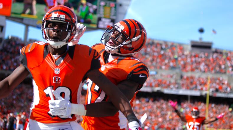 Bengals wide receivers Brandon Tate, left, and Mohamed Sanu celebrate a touchdown catch by Tate against the Chiefs on Sunday, Oct. 4, 2015, at Paul Brown Stadium in Cincinnati. David Jablonski/Staff