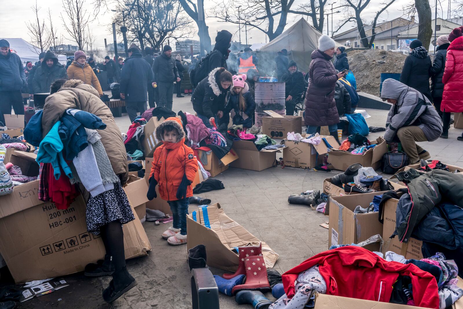 People who fled the fighting near their homes pick up donated clothing outside the central train station in Lviv, Ukraine, on Wednesday, March 9, 2022. With Ukrainian resistance holding firm and Western penalties seemingly toughening by the hour, the cost to Russia of its troubled, nearly two-week invasion mounted on Wednesday as its Central Bank limited withdrawals of foreign currency to protect the crashing ruble and the Kremlin’s spokesman accused the United States of waging an “economic war.” (Brendan Hoffman/The New York Times)