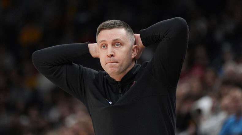 Ohio State interim head coach Jake Diebler watches the first half of an NCAA college basketball game against Iowa in the second round of the Big Ten Conference tournament, Thursday, March 14, 2024, in Minneapolis. (AP Photo/Abbie Parr)
