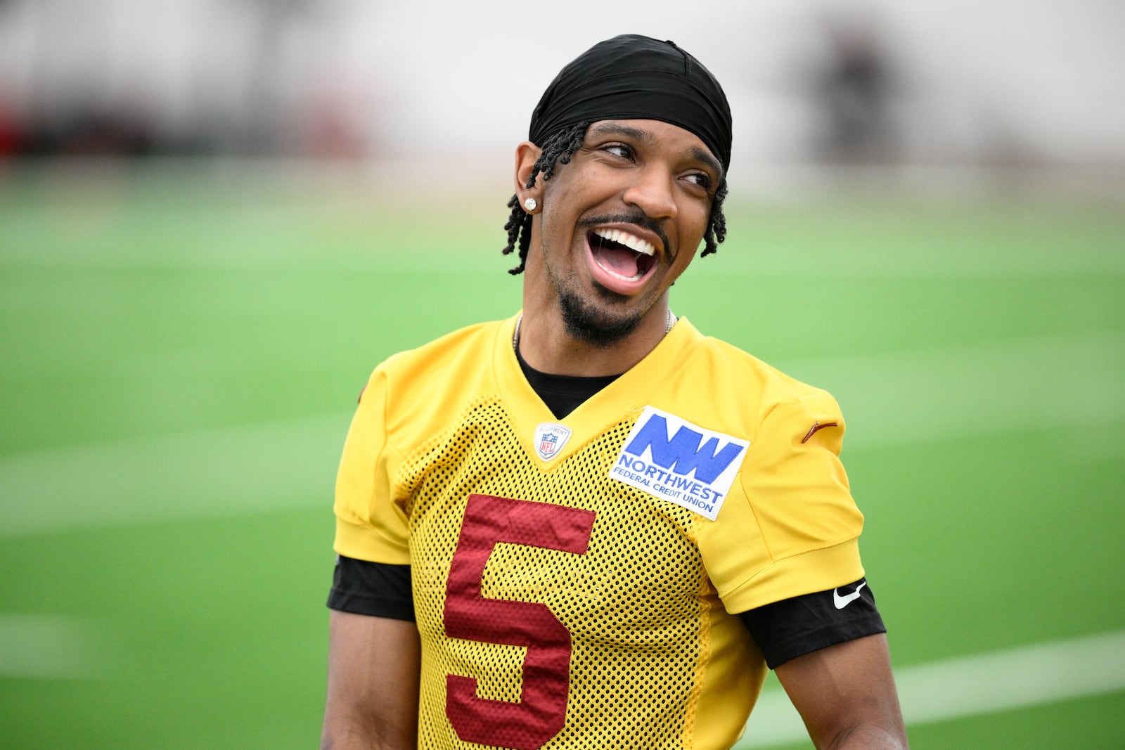Washington Commanders quarterback Jayden Daniels reacts during NFL football practice, Wednesday, May 28, 2025, in Ashburn, Va. (AP Photo/Nick Wass)