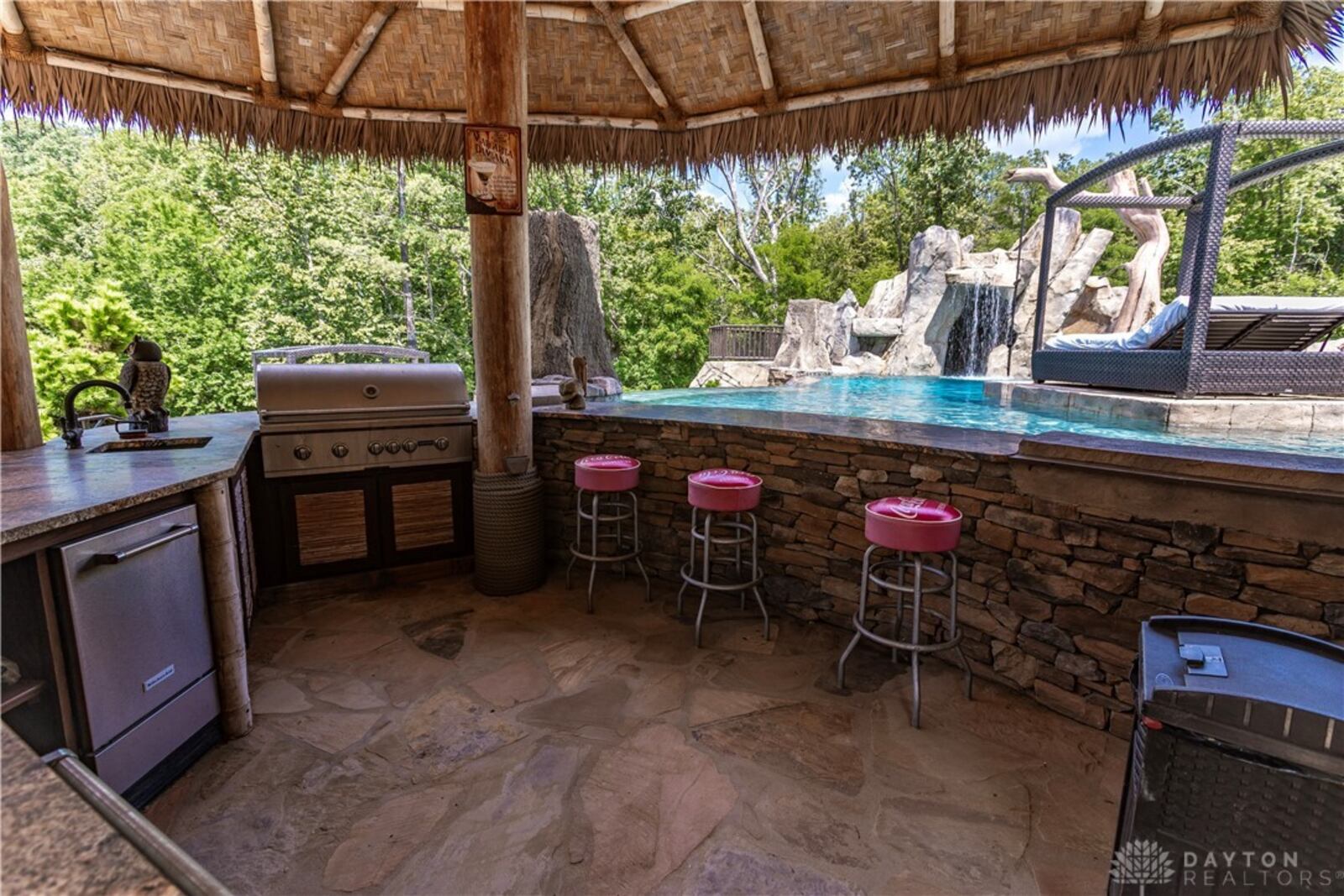 The backyard has a resort like feel with an inground infinity edge pool, outdoor kitchen and tiki bar. CONTRIBUTED