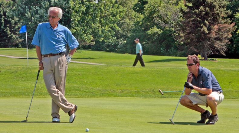 Marty Brennaman, long-time broadcast partner of the late Joe Nuxhall, and Steve Burns watch as another golfer make a put Monday, June, 16, 2008, during the Joe Nuxhall Scholarship Foundation golf outing at the Hamilton Elks Golf Club in Hamilton, Ohio. FILE PHOTO