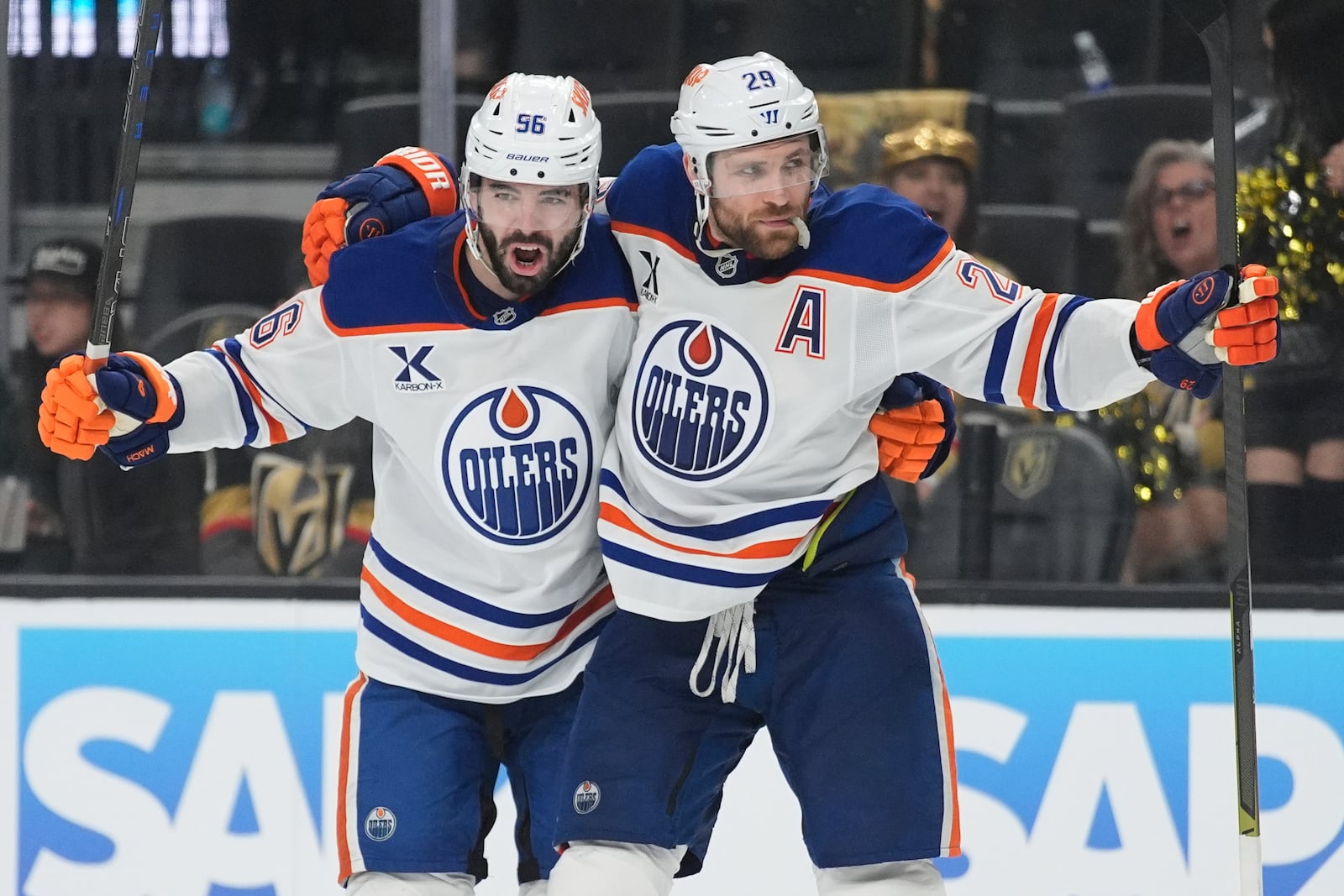 Edmonton Oilers center Leon Draisaitl (29) celebrates with teammates after scoring against the Vegas Golden Knights during the third period of Game 1 of a second-round NHL hockey playoff series Tuesday, May 6, 2025, in Las Vegas. (AP Photo/John Locher)