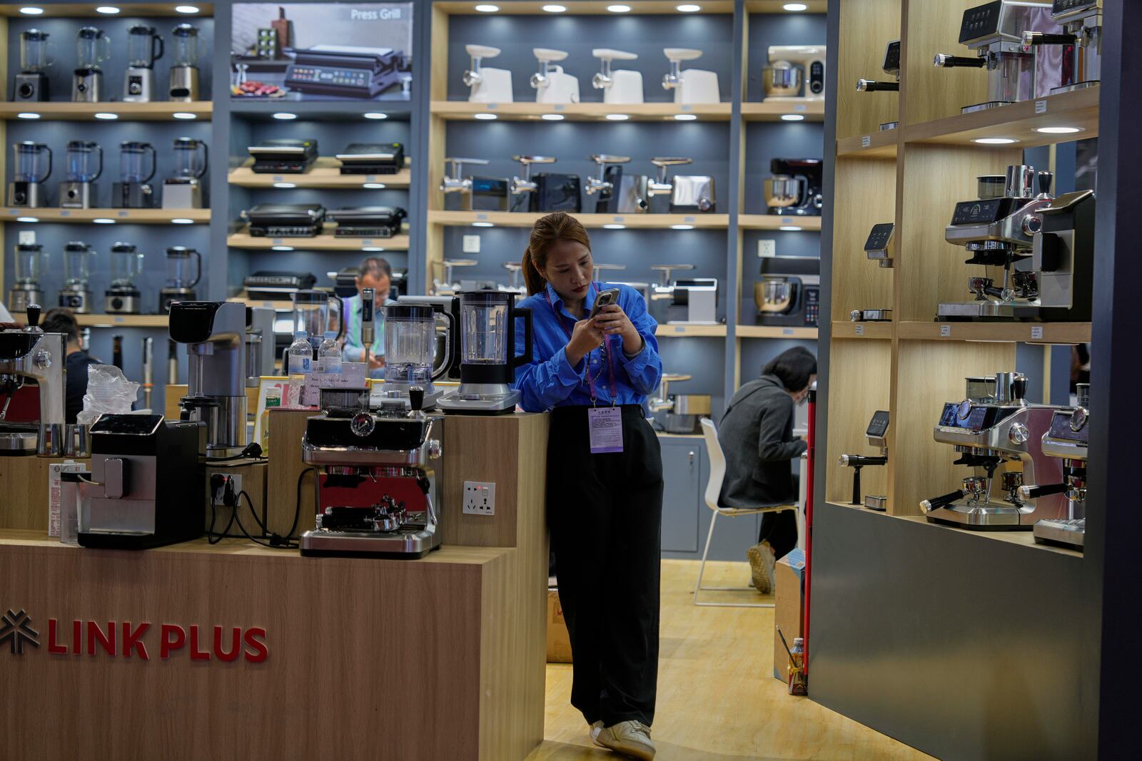 A vendor of coffee machines waits for customers at the 137th Canton Fair in Guangzhou in southern China's Guangdong province on Wednesday, April 16, 2025. (AP Photo/Ng Han Guan)