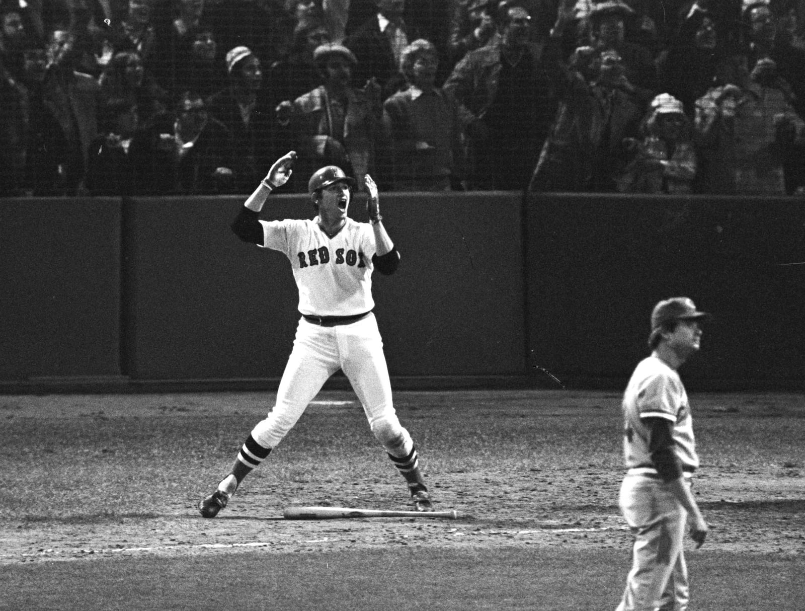 This October 22, 1975 file photograph shows Boston Red Sox catcher Carlton Fisk gesturing as his 12th-inning home run hits the left field foul pole to give Boston the sixth game of the World Series against the Cincinnati Reds. (AP Photo/Harry Cabluck)