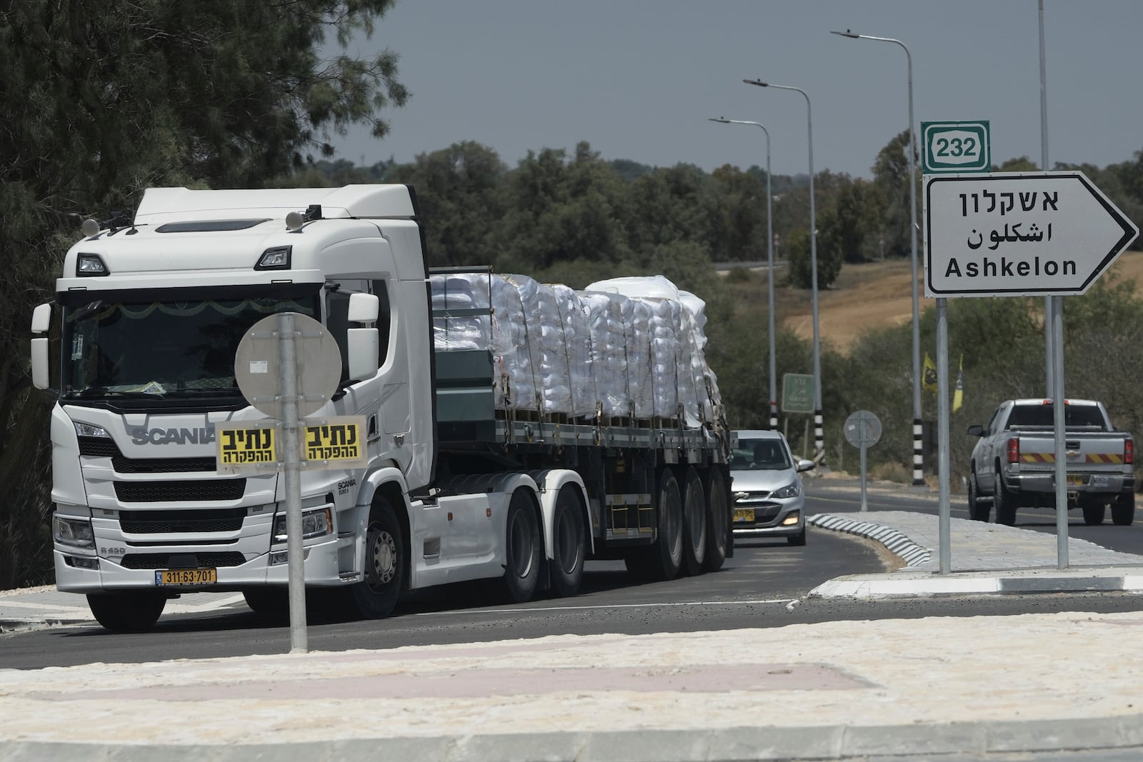 A truck loaded with humanitarian aid for the Gaza Strip makes its way to the Kerem Shalom crossing in southern Israel, in Israel-Gaza border, Tuesday, May 20, 2025. (AP Photo/Maya Alleruzzo)
