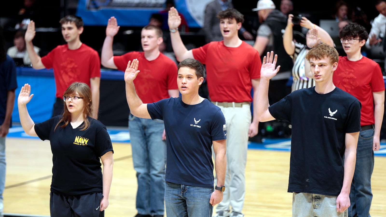 New recruits of multiple military branches, including Army, Navy, Air Force and Marines, were swore in during halftime of First Four game featuring Maryland Baltimore County and Howard on Tuesday, March 17, 2026, at UD Arena. STEVEN WRIGHT / STAFF